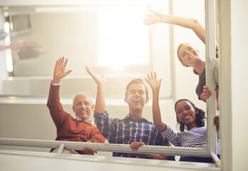 Poster - Hi form the top. Portrait of a group of smiling coworkers waving at the camera while standing in a stairwell.