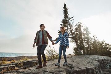 Wall Mural - Were hikers at heart. a happy couple out hiking hand in hand.