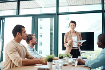 Poster - Understand where Im going with this idea. a young businesswoman giving a presentation to her colleagues in an office.