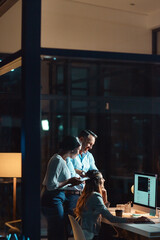 Poster - Productivity doesnt have a clock out time. a group of businesspeople using a computer during a late night at work.