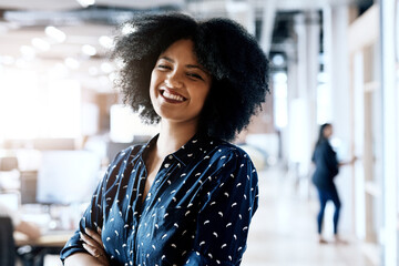 Poster - Success brings a smile to my face. Portrait of a young female designer posing with her arms folded in the office.