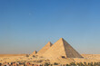 View of the area with the great pyramids of Giza, Egypt with the moon in the background
