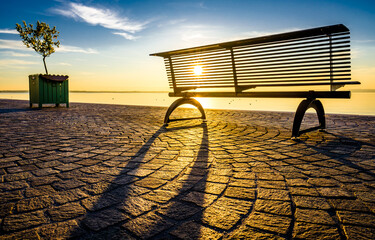 Canvas Print - bench at a lake