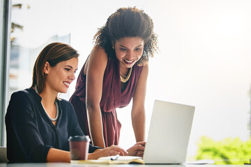 Poster - Modern technology makes for maximised workflow. two businesswomen working together on a laptop in an office.