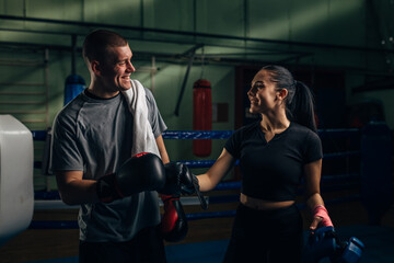 Male and female fighter give high five after a hard training.