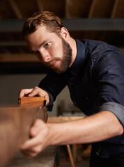 Wall Mural - Carpenter, wood sanding and man working on building construction and architecture project. Home improvement, maintenance and handyman work of a young male employee with carpentry tool for woodwork