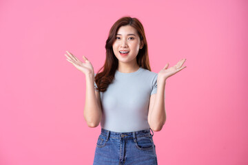 portrait of young asian girl posing on pink background