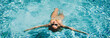 © simona - Active female swimming in blue pool water and enjoy summer holiday vacation. People in outdoor leisure activity. Lady in relaxation day swim and enjoy relax. Banner header. Healthy lifestyle