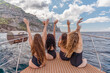 © svetograph - Womans on a yacht. Happy models in a swimsuit posing on a yacht against a blue sky with clouds and mountains