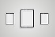 Three picture frames with black blank hanging on the whitewall for mock up design, vector black photo frames in diferent sizes of wooden Frames Hanging on the wall