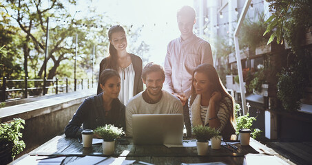 Poster - Gathered to get a team task completed. a team of colleagues using a laptop together during a meeting at an outdoor cafe.
