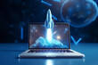 © alones - Blue rocket lift off of a laptop on a desktop, concept. Faster application, creative idea. Startup development and growth