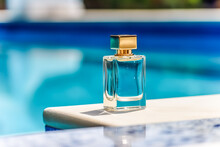Luxury Perfume Bottle With Golden Cap By The Swimming Pool In Summer. Generative AI