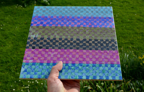 people design their own tile patterns. there are no limits to imagination. they fix the creative pattern of the checkerboard. cheerful colors and green grass harmonize with the surrounding garden.