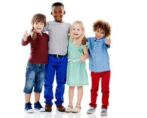 Kids, group and thumbs up for diversity in studio portrait with smile, hug or care by white background. Girl, boy or isolated friends for happiness, hand sign or solidarity for children with kindness