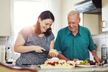 Poster - Its an honor to care for aging parents. a woman making her senior male parent a sandwich.