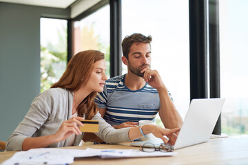 Poster - Which one do you like best. a young couple working on their household budget and paying bills online.