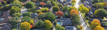Panorama Quite Curved Residential Street And Colorful Autumn Leaves Surrounding Residential Houses With Swimming Pool, Fenced Backyard In Upscale Neighborhood Dallas, Texas, USA