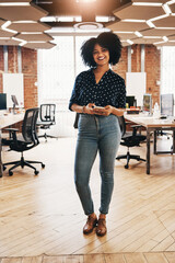 Poster - Im always online and chatting with clients at work. Full length portrait of a cheerful young female designer holding a cellphone while standing inside of her office.