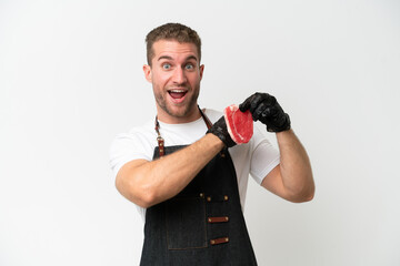 Wall Mural - Butcher caucasian man wearing an apron and serving fresh cut meat isolated on white background celebrating a victory