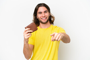 Wall Mural - Young handsome man holding a wallet isolated on white background points finger at you with a confident expression