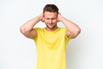 Wall Mural - Young blonde caucasian man isolated on white background frustrated and covering ears