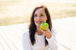 © luismolinero - Middle aged woman holding an apple with happy expression