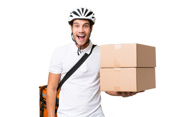 Delivery man wearing a helmet bike over isolated background with surprise facial expression