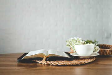 Open bible, flowers and a cup of tea, space for text