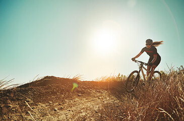 Not for the weak of will. an adventurous woman out cycling in the countryside.