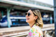 © jorge - woman is looking at arriving train at a railway station