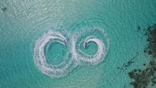 Jet skis make circles on the water in the Maldives