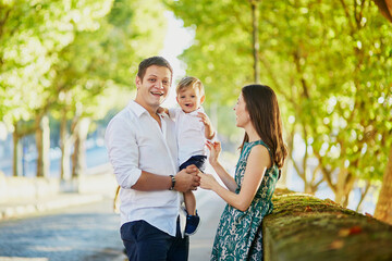 Wall Mural - Happy family of three enjoying their vacation in Paris