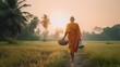 Buddhist monk with good spiritual going about with alms bowl to receive food from villager by walking in row across rice field with palm trees to village in Thailand, Generative AI