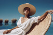Beautiful spectacular young woman model in a white dress and hat against a bright blue sky on a sunny day. Generative AI