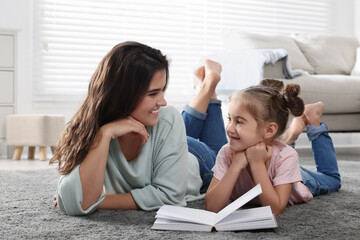 Wall Mural - Young mother and her daughter spending time together at home