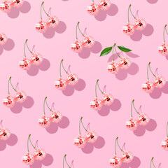 Trendy pattern composition made with Decorative disco balls like cherries on pastel pink background. Concept of minimal entertainment. Flat lai. Contemporary style. Creative art, minimal aesthetics.
