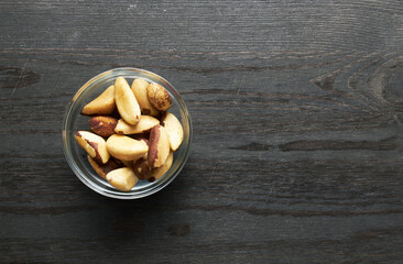 Wall Mural - Bertholletia brazil nuts in bowl on a wood