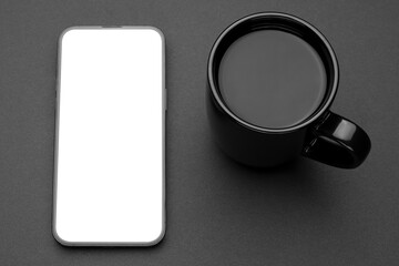 Mockup display. Mobile cell phone blank screen. Smartphone technology. Office workplace with cup of tea or coffee. Smart phone. Mock up device for application, website design project. Dark Background