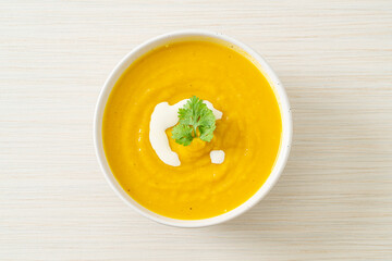 Wall Mural - pumpkin soup in white bowl