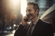 © Lee John - Businessman Smiling on Phone Call in the Busy City with Sun Rays With Generative AI Technology