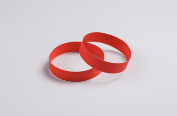 Wall Mural - Red paper bracelets on gray background