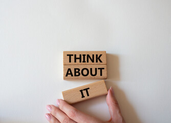 Think about it symbol. Wooden blocks with words Think about it. Beautiful white background. Businessman hand. Business and Think about it concept. Copy space.