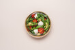 Cardboard bowl container with fresh caprese salad. Food delivery, zero waste, recycling packaging, eco friendly concept