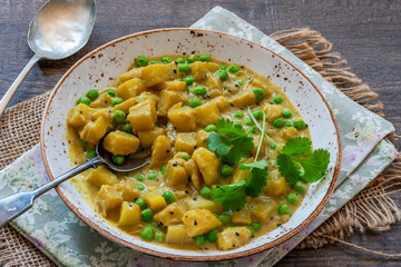 Wall Mural - Coconut and potato curry with green peas