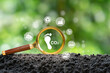 icon carbon footprint in magnifier glass for emission and carbon credit to limit global warming from climate change and Reduce CO2 emission concept for sustainable