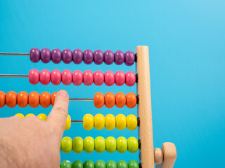 Wooden abacus on a blue background, Wooden abacus for children. Wooden abacus close-up.