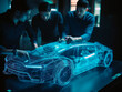 Car design engineers using holographic app in digital