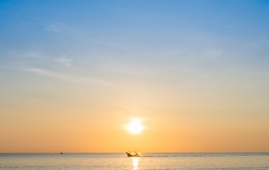 Wall Mural - sunset sky clouds over sea in the morning with orange sunrise over traditional fishing boat, landsca