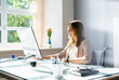 © Andrey Popov - Businesswoman Using Desktop Computer